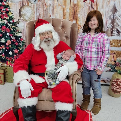 Kids enjoying a magical moment with Santa at the 'Breakfast with Santa' event, sponsored by PTO.