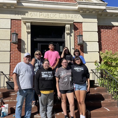 Horton High students assist with yardwork and cleaning windows.