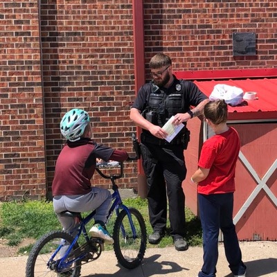 Officer Entrikin providing bicycle safety courses during the First Annual Bike Rally