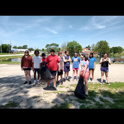 Senior high campers pick up trash around Mission Lake on June 11, 2025.