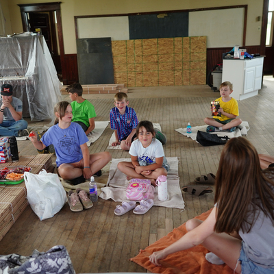 Students celebrate the last day of school with a hot dog lunch in the schoolhouse.